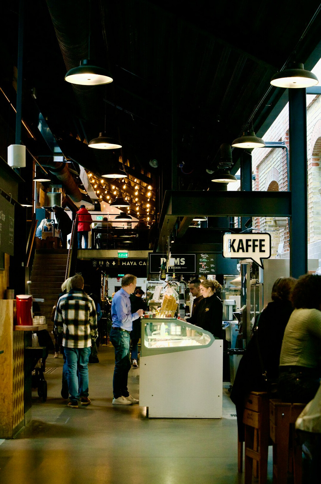 Customers lined up inside a cozy Copenhagen coffee shop